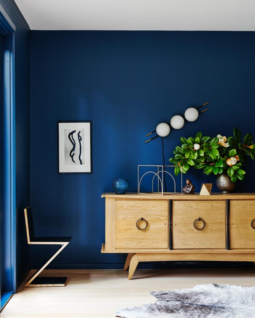blue walls with light wood media console