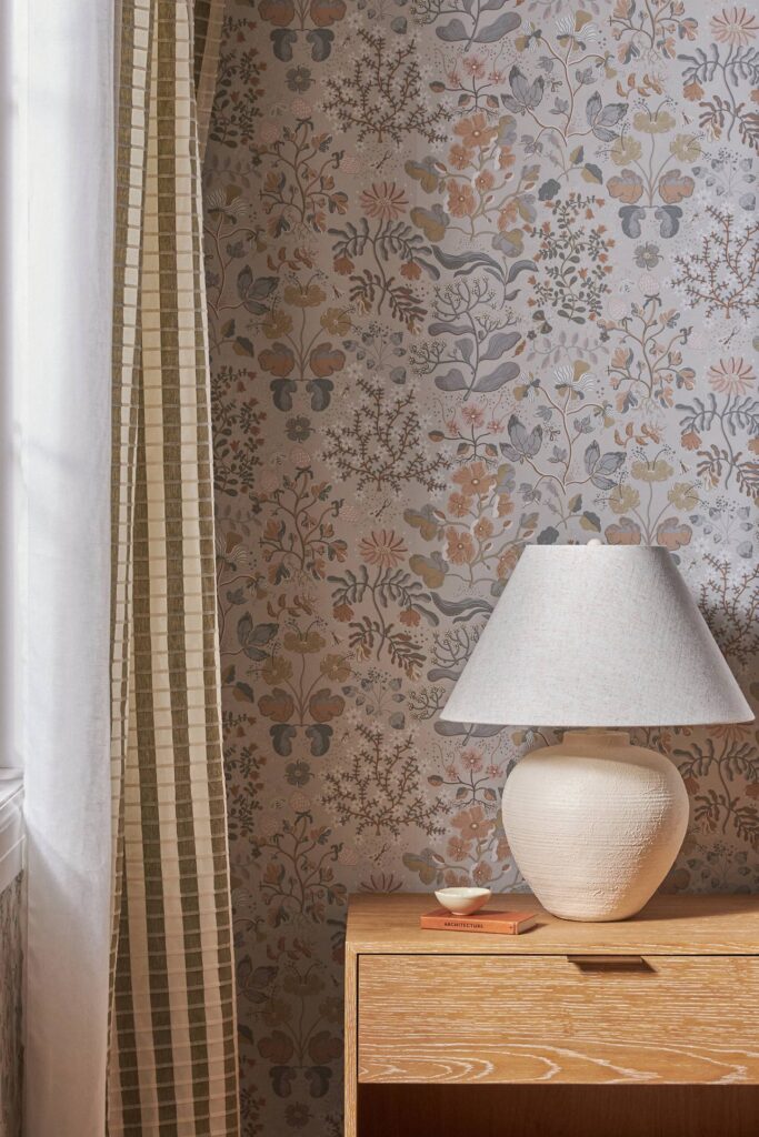 side table with lamp and neutral floral wallpaper