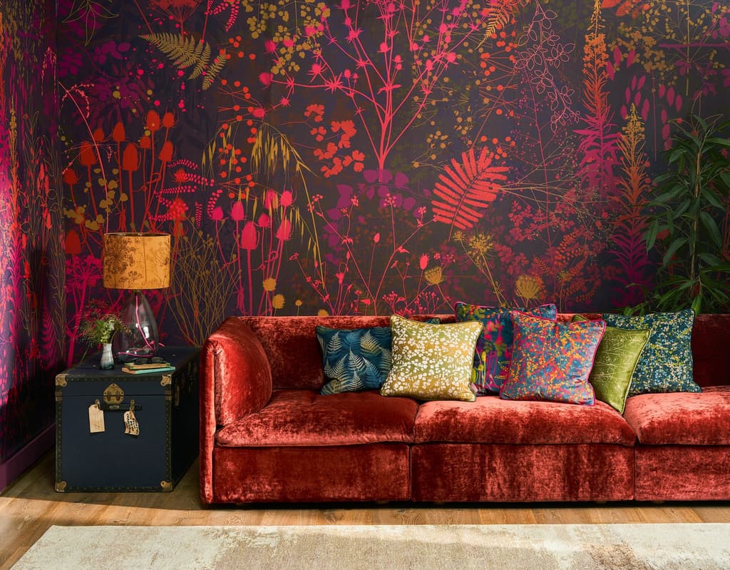 Bold pink, purple, and red wallpaper in a sitting room