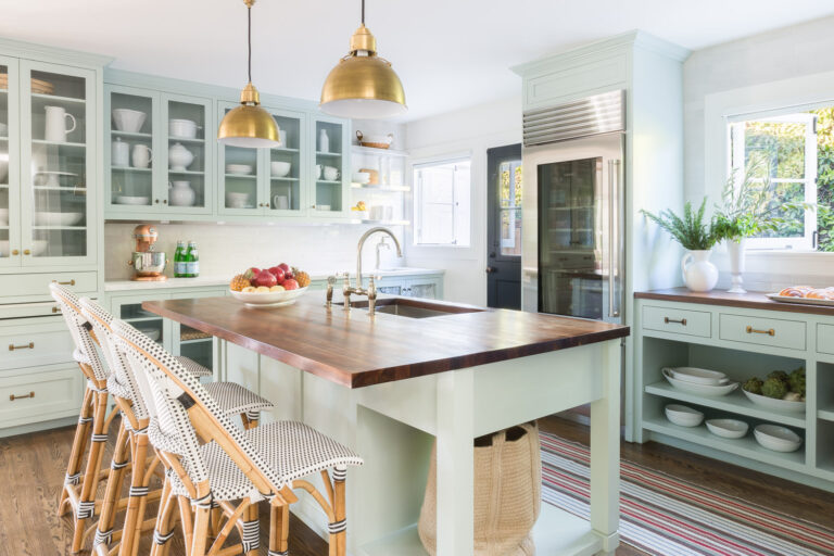 Pastel green cabinetry and light wood accents