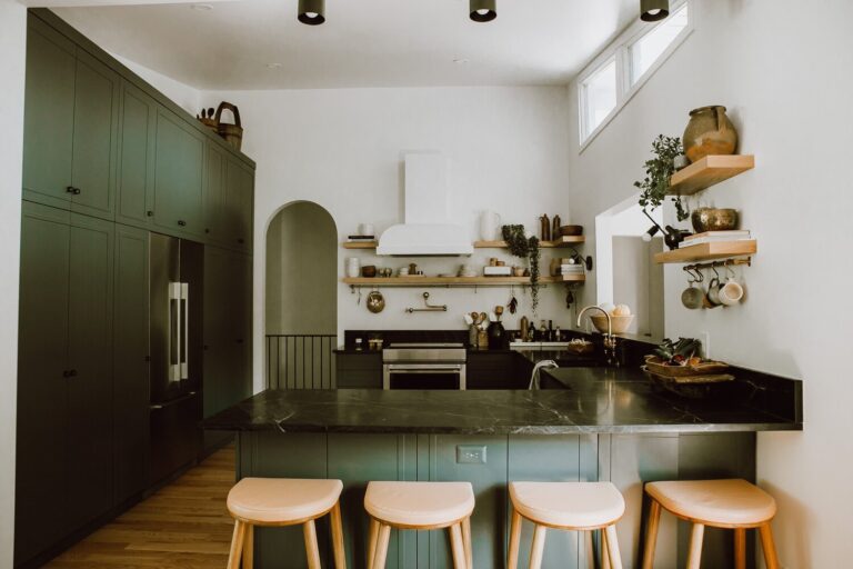 Dark green cabinets and countertop with light wood accents
