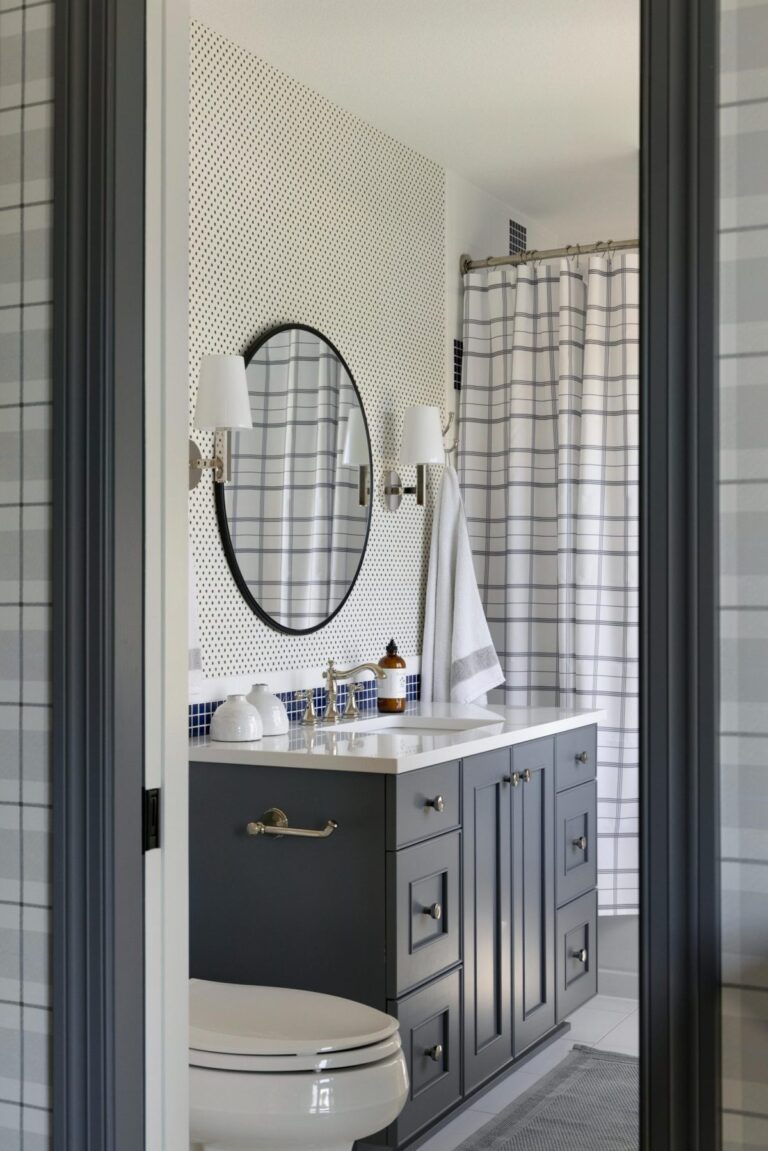 White bathroom with navy blue cabinets
