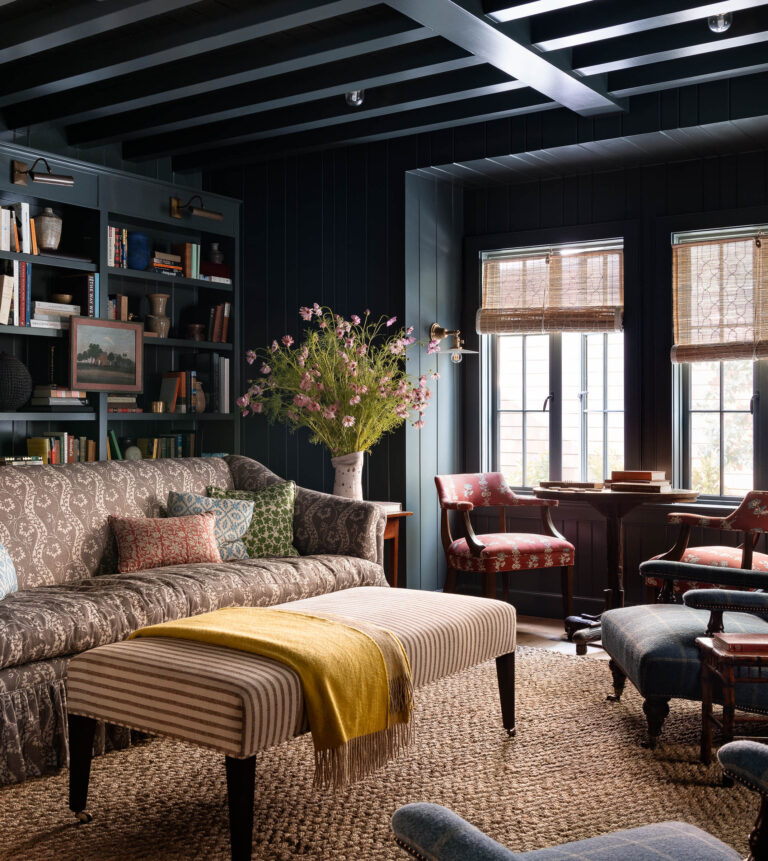 Dark painted walls and ceiling and light colored furniture
