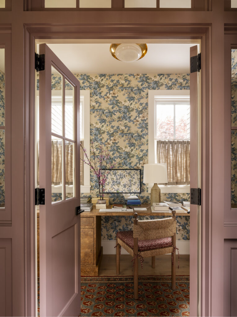 Home office with dusty pink painted trim and floral wallpaper