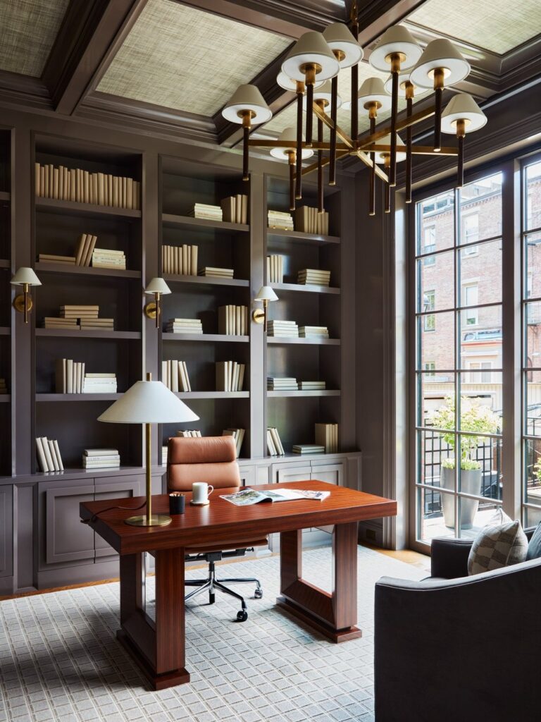 grand home office with layered chandelier and desk lamp