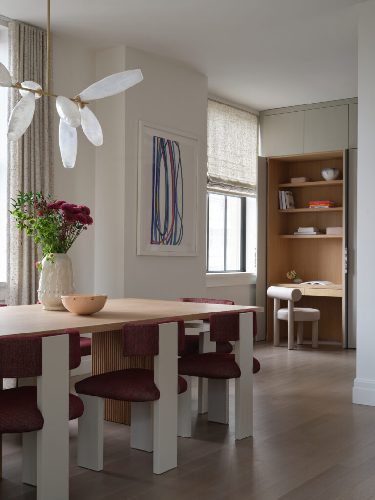 Simplified space with a dining room table and built in desk