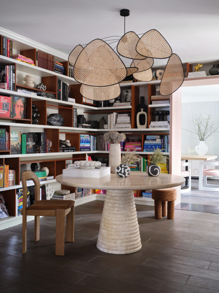 Sitting room with floor to ceiling bookshelves and light fixture