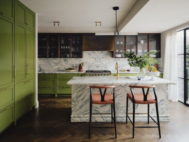 Moss green cabinets and white marble accents