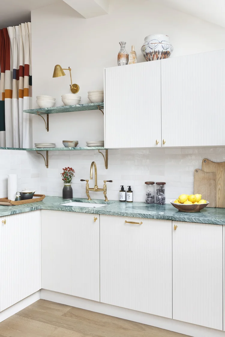 Green marble countertops in white kitchen