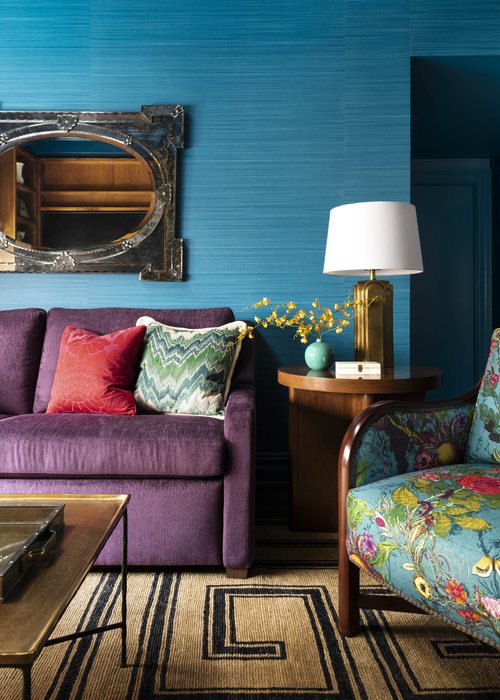 sitting room with teal walls, purple couch and other colors