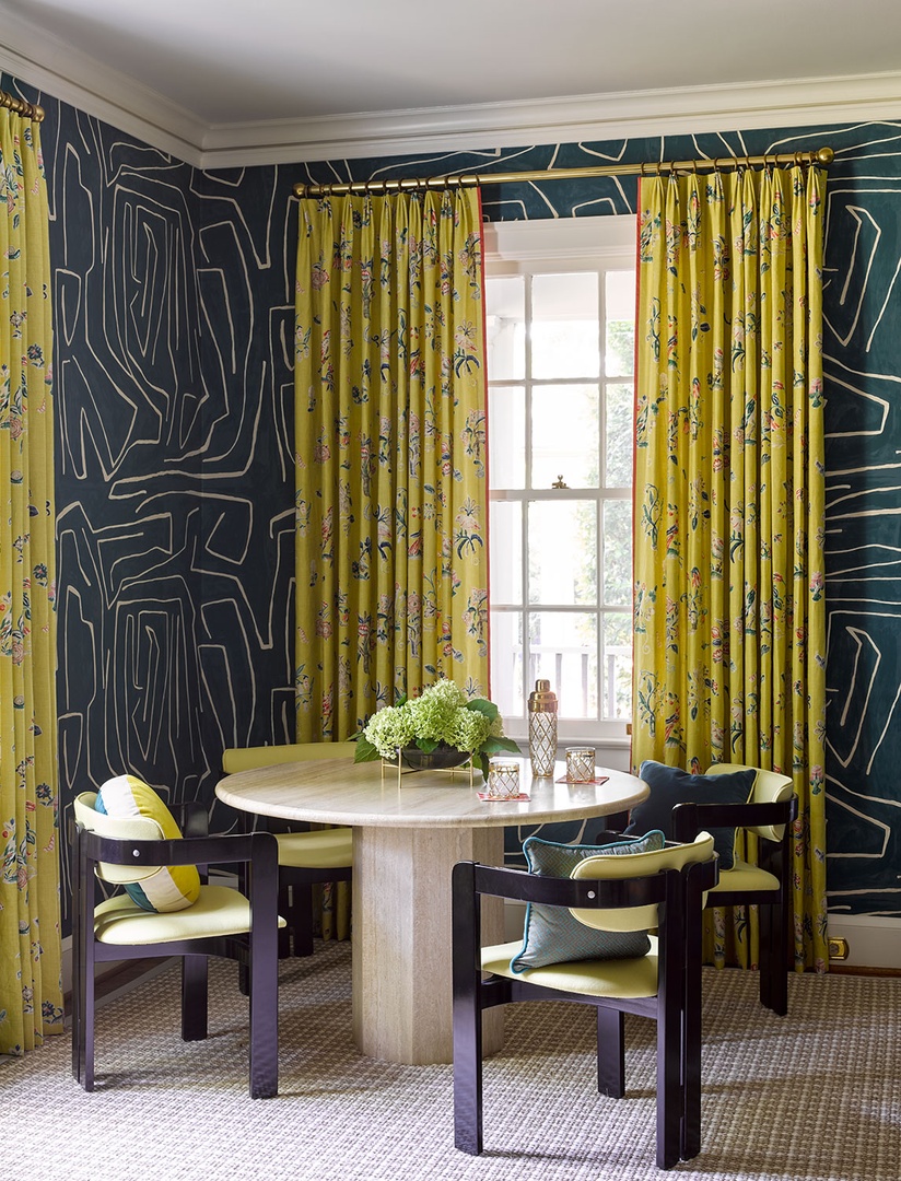 indigo wallpaper with chartreuse curtains and chairs in a dining room