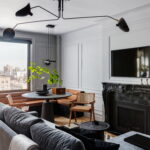 Apartment with small corner table, couch, and fireplace