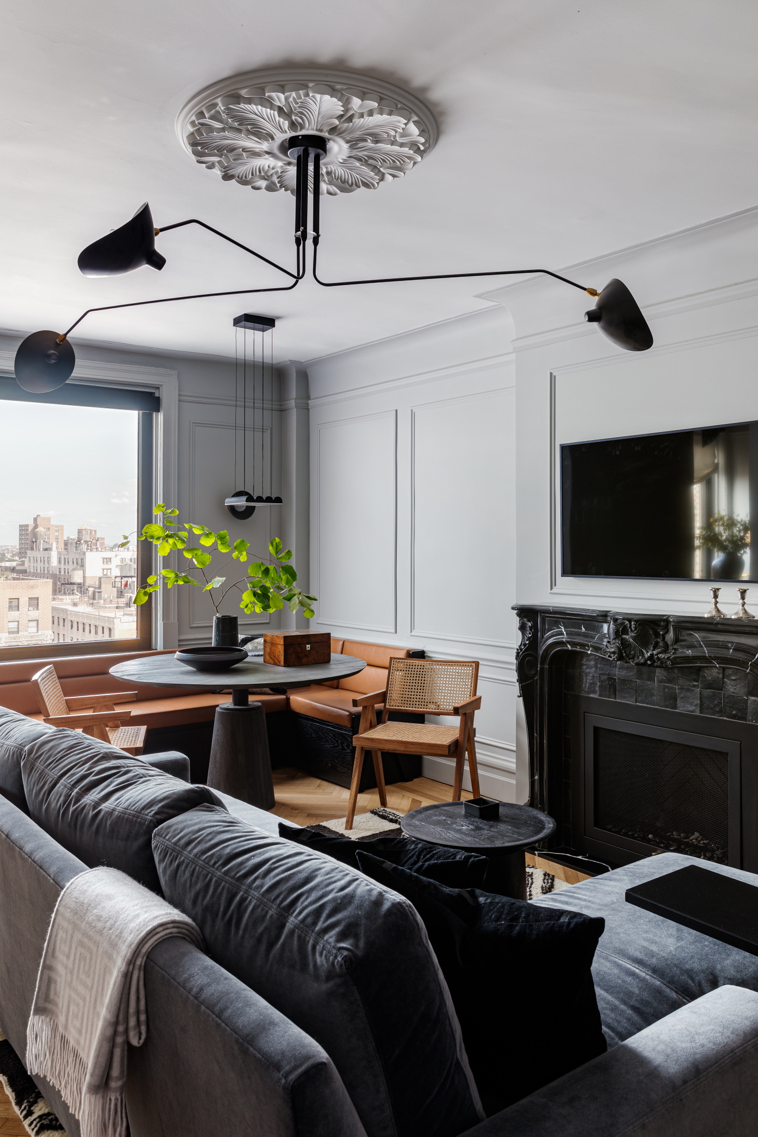 Apartment with small corner table, couch, and fireplace