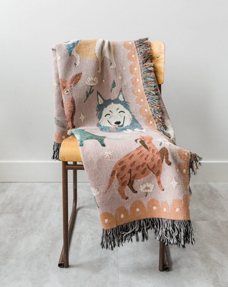 Frankie Print Co. dog throw blanket over a chair