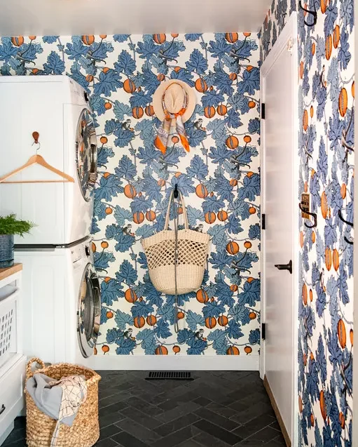 bold blue and orange wallpaper in laundry room