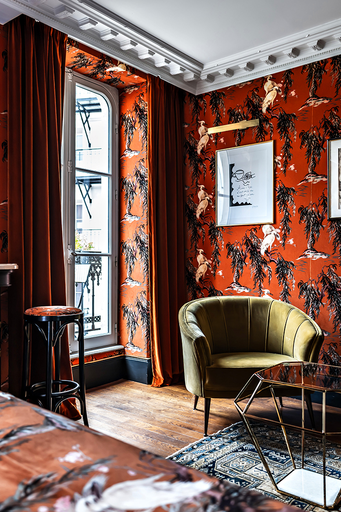 Reddish orange bird motif wallpaper in a guest room at Hôtel Providence in Paris, France