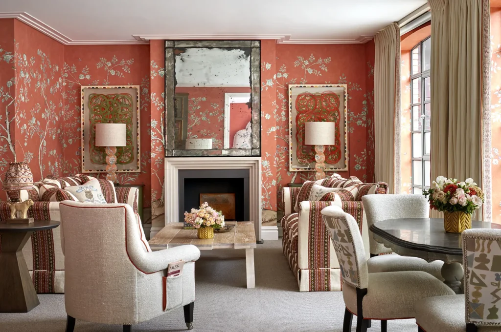 Reddish orange floral print wallpapered guest room at The Soho Hotel in London, England