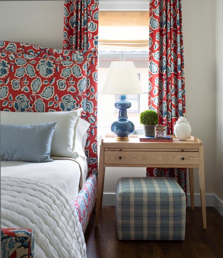 Red and pale blue floral print headboard and curtains