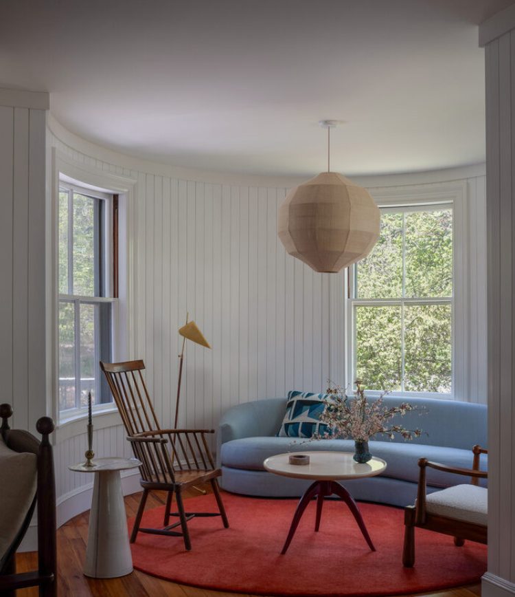 Red rug and pale blue couch in sitting room