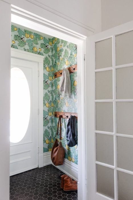 green floral wallpaper and white door vestibule